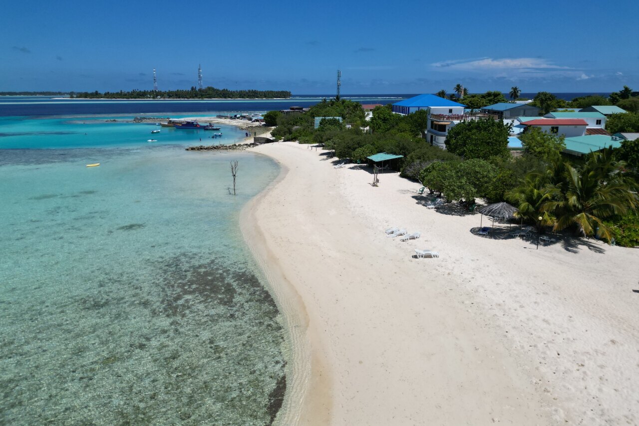 Aerial view of the white sandy beach and turquoise water at Keyodhoo local island in the beautiful Vaavu Atoll.
