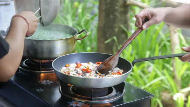 activity, food - Hands-on preparation of traditional local dishes in a Maldivian cooking class with a frying pan and boiling pot.