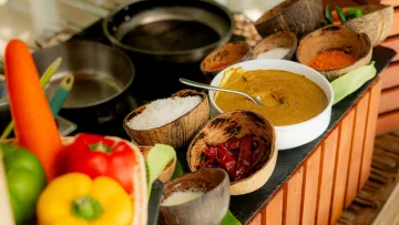 activity, food - Assorted fresh ingredients and spices in coconut bowls used for a traditional Maldivian cooking class on an island.