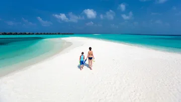 activity, beach, people, sea, snorkeling - Mother and son walking on a pristine white sandbank with snorkel gear, surrounded by turquoise ocean waters.