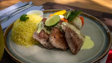 food - A close-up of a gourmet meal of a typical Maldivian dish. Grilled tuna steak, coconut milk curry, rice and vegetables.