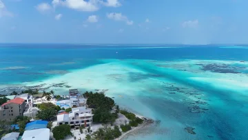 drone-shot, local-island, nature, sea - Aerial drone shot of Dhiffushi local island showing buildings surrounded by a turquoise shallow lagoon in the Maldives.