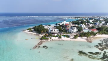 beach, drone-shot, local-island, sea - Aerial perspective of Dhiffushi island showing white sand beaches, turquoise lagoon waters, and local hotels.