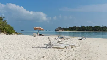beach, bikini-beach, local-island, relax - Sunbeds and parasol on the pristine white sandy beach of Dhiffushi island with clear turquoise ocean water.