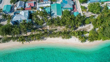 beach, drone-shot, local-island, nature - Aerial drone shot of the local island Felidhoo in Vaavu Atoll, showing houses, lush palm trees, and sandy beach.