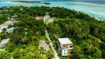 drone-shot, local-island, nature - An aerial drone view showing the lush green Fenfushi local island in Alifu Dhaalu Atoll surrounded by turquoise sea.