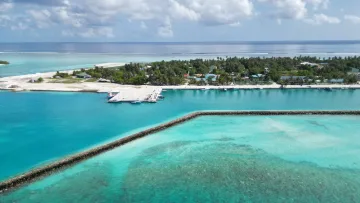 drone-shot, local-island - Aerial drone shot of the local island of Fenfushi in Alifu Dhaalu Atoll, showing the boat jetty and clear blue waters.