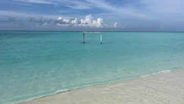 beach, local-island - A wooden swing standing in the crystal clear turquoise water off the beach of Fenfushi Island in Alifu Dhaalu Atoll