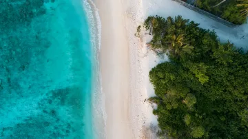 beach, drone-shot, local-island, nature, sea - Stunning aerial drone view of the turquoise lagoon, white sandy beach, and lush green vegetation on Feridhoo island, Alifu Alifu Atoll.