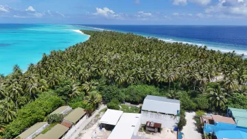 drone-shot, local-island, nature, sea - Aerial drone shot of the tropical island of Fulhadhoo in Baa Atoll, showing lush palm forest and turquoise lagoon.