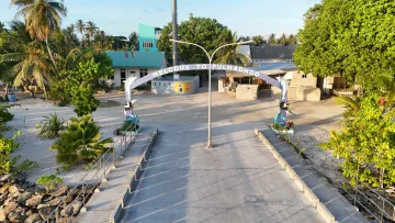drone-shot, local-island - Drone view of the welcome arch at the entrance of Fulhadhoo local island in Baa Atoll, Maldives at sunset.
