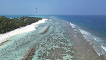 beach, drone-shot, local-island, nature, reef - Drone aerial view of the tropical Fulidhoo Island in Vaavu Atoll with white beach and surrounding reef structures.