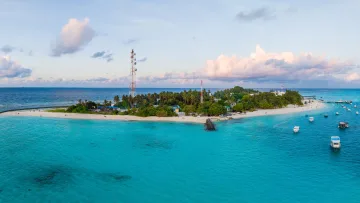drone-shot, local-island, sunset - A beautiful drone shot of Fulidhoo local island in Vaavu Atoll with boats anchored in the turquoise lagoon at sunset