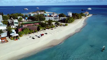 beach, bikini-beach, drone-shot, local-island, sea - Aerial view of the beach, turquoise waters, and lush vegetation of Gulhi Island located in the Kaafu Atoll.