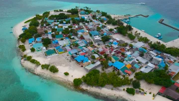 drone-shot, local-island - Aerial perspective of Gulhi local island in Kaafu Atoll, featuring colorful houses, white sandy beaches and ocean.