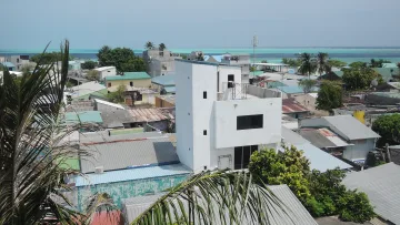 local-island - Overlooking the rooftops of Gulhi Island in the Kaafu Atoll, surrounded by the clear turquoise Maldivian sea.