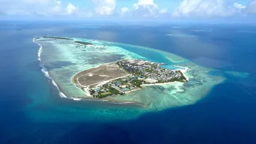 drone-shot, local-island, nature, reef, sea - Aerial drone perspective of Hinmafushi local island in Kaafu Atoll, surrounded by crystal clear lagoon and reef.