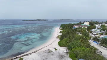 bikini-beach, drone-shot, local-island - Aerial perspective of the white sandy beach and tropical vegetation of Hinmafushi island, North Male Atoll, Maldives.