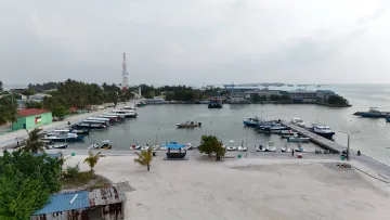 local-island - Aerial view of the busy harbor with many docked speedboats and local vessels at Hinmafushi island, Kaafu Atoll.