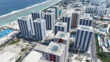 local-island - Aerial view of high-rise apartment towers in Hulhumale local island, Kaafu Atoll, with the ocean and coast visible.
