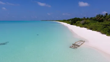 beach, drone-shot, local-island, nature, sea - Aerial view of a wrecked boat on the white sandy beach of Kelaa local island, Haa Alifu atoll, Maldives.
