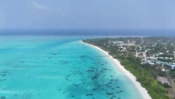drone-shot, local-island, nature, sea - Drone perspective of the white sand beach and crystal clear lagoon of Kelaa Island in the Haa Alifu Atoll, Maldives.
