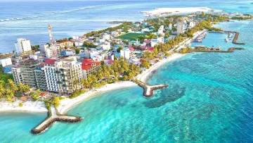 beach, drone-shot, local-island - A drone shot capturing the beautiful Maafushi local island in Kaafu Atoll, showing hotels, beaches and turquoise sea.