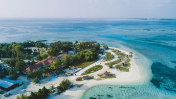 drone-shot, local-island, nature, sea - Aerial view of the local Maafushi island in Kaafu Atoll showing the coastline, tropical vegetation, and clear sea
