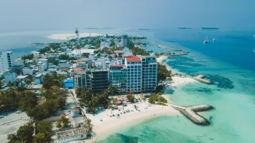 beach, bikini-beach, drone-shot, local-island - Aerial drone shot of Maafushi local island in Kaafu Atoll, showcasing its hotels, white beach and clear turquoise sea.