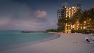 beach, bikini-beach, local-island, sunset - Evening view of white sandy beach with sun loungers on Maafushi island in the Kaafu atoll during the sunset hour.
