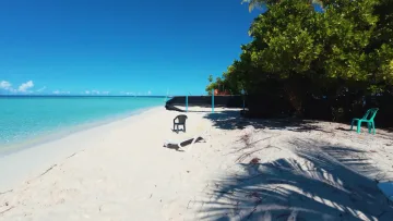 beach, bikini-beach, local-island, relax - Sunny beach with lounge chairs at Omadhoo local island in Alifu Dhaalu Atoll, surrounded by tropical greenery.