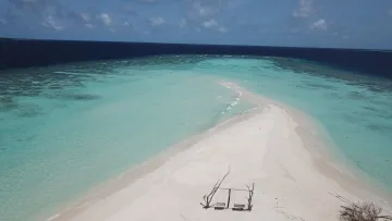beach, drone-shot, local-island, sea - Aerial view of a white sandbank with a wooden swing at Omadhoo island in Alifu Dhaalu Atoll, surrounded by turquoise water.