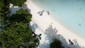 beach, bikini-beach, drone-shot, local-island, people, relax - Aerial top down drone shot of tourists relaxing on white sand beach in Rasdhoo local island, North Ari Atoll Maldives