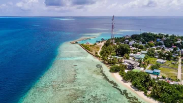 drone-shot, local-island, sea - Aerial drone perspective of the local island of Rasdhoo in the North Ari Atoll featuring houses, harbor and reef.