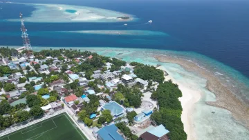 drone-shot, local-island - Drone perspective of Rasdhoo local island in Alifu Alifu atoll, showcasing the football field and turquoise water
