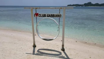 beach, local-island, relax - A round beach swing with a sign reading I Love Club Gabbiano on the white sand beach of Rasdhoo island, Alifu Atoll.