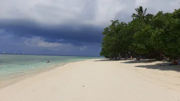 beach, bikini-beach, local-island, nature, people - View of the sandy bikini beach on Rasdhoo local island in Alifu Atoll with lush trees, tourists and cloudy sky.