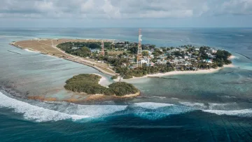 drone-shot, local-island, sea - Ripresa aerea dell'isola locale di Thulusdhoo nell'atollo di Kaafu, con il villaggio, la spiaggia e la barriera.