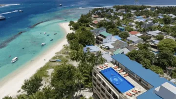 beach, drone-shot, local-island, relax, sea - Vista aerea di una piscina sul tetto dell'hotel che affaccia sulla spiaggia e l'acqua turchese di Thulusdhoo, Kaafu.