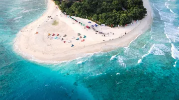 beach, bikini-beach, drone-shot, local-island, people - Ripresa aerea con drone di un evento pubblico sulla spiaggia di Ukulhas, atollo di Alifu Alifu, con ombrelloni colorati.