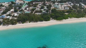 drone-shot, local-island - Stunning aerial drone view of the local island of Vashafaru in Haa Alifu Atoll, showing the village and sandy beach.
