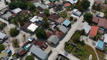 drone-shot, local-island - An aerial drone view showing the residential houses and sandy streets of Vashafaru local island in Haa Alifu Atoll.