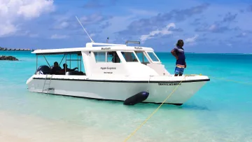 local-island, people, sea - A local speed boat named Apple Express moored in the crystal clear turquoise water near the sandy beach of Maafushi.