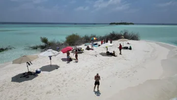 Aerial view of tourists enjoying the sunny Madivaru sandbank near Rasdhoo island in the North Ari Atoll Maldives