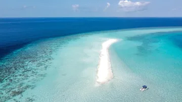 drone-shot, nature, sea - Drone perspective of an elongated white sandbank surrounded by turquoise shallow waters and a deep blue ocean with a small boat anchored nearby.