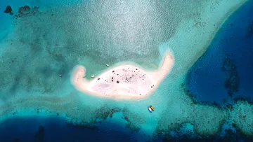 drone-shot, nature, sea - Aerial view from above of a small white sandbank surrounded by vibrant turquoise shallow water and dark blue ocean