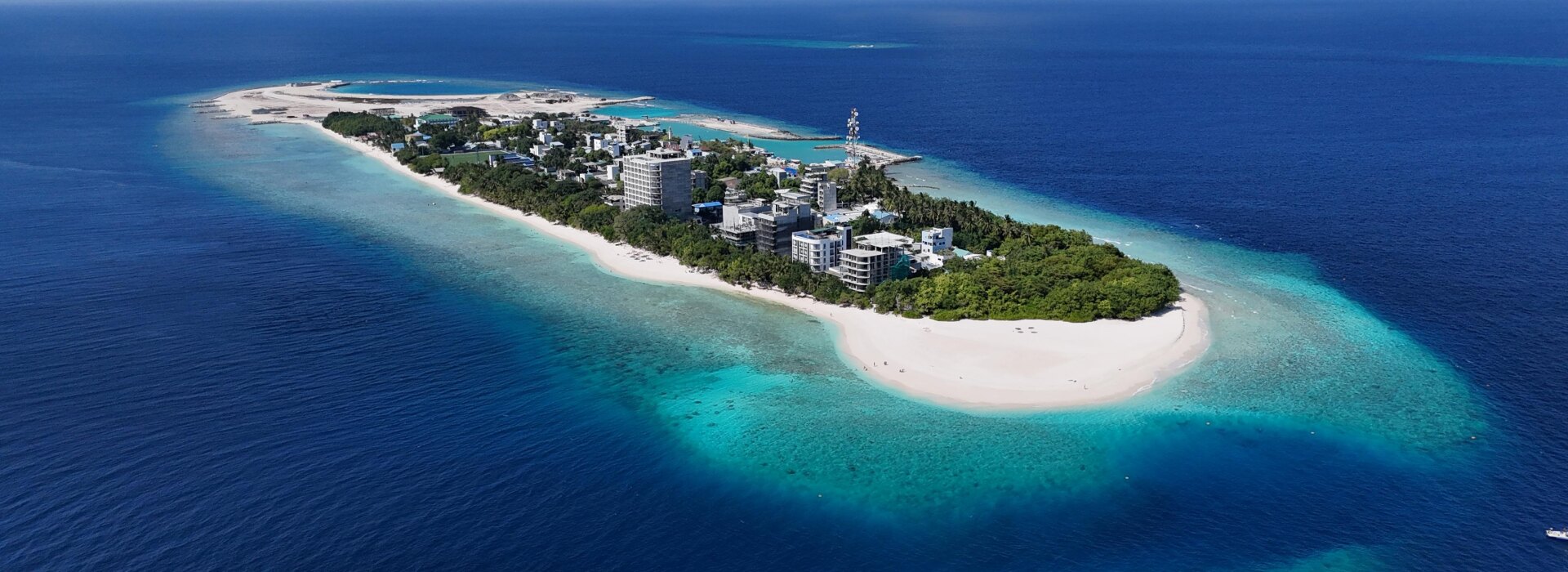 Prospettiva aerea dell'isola locale di Ukulhas nell'atollo di Alifu Alifu, con la spiaggia bianca e la barriera