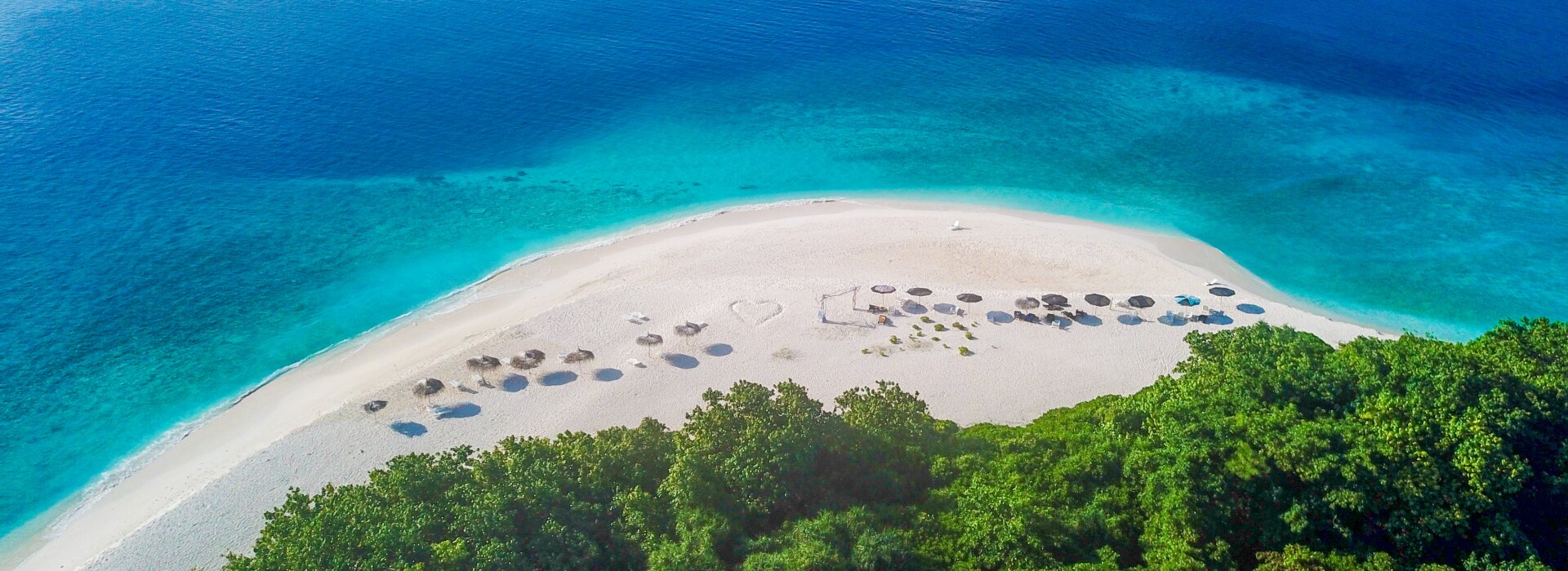Stunning aerial drone view of the tropical white sandbank on Ukulhas local island in Alifu Alifu Atoll, Maldives.